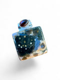 Making Waves Jewelry and Accessories square ocean jasper pendant with a red garnet accent in sterling silver setting.
