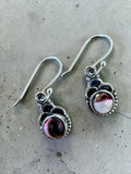 Making Waves Jewelry and Accessories sterling silver dangle earrings with burgundy and white stone inlay and beadwork.