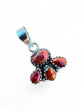 Making Waves Jewelry and Accessories sterling silver pendant with four red and orange gemstones in bezel settings.