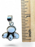 Making Waves Jewelry and Accessories sterling silver pendant with white stone cluster and rope detailing next to ruler