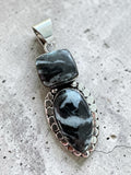 Making Waves Jewelry and Accessories artisan pendant with black and white stone in a scalloped sterling silver setting.