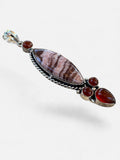 Making Waves Jewelry and Accessories artisan stone pendant with twisted silver, brown patterned stone, and red carnelian