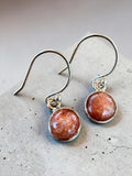 Making Waves Jewelry and Accessories round sunstone drop earrings in polished 925 sterling silver settings.