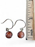 Making Waves Jewelry and Accessories round sunstone drop earrings in polished 925 sterling silver with hook backings.