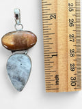 Making Waves Jewelry and Accessories sterling silver pendant with oval sunstone and teardrop moonstone next to a ruler