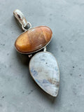 Making Waves Jewelry and Accessories sterling silver pendant featuring an oval sunstone and a teardrop moonstone.