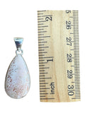 Making Waves Jewelry and Accessories teardrop sunstone pendant in a polished sterling silver bezel next to a ruler.