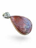Making Waves Jewelry and Accessories teardrop Crazy Lace Agate pendant with silver filigree bail and polished finish.