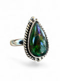 Making Waves Jewelry and Accessories teardrop Ammolite ring in sterling silver with rope detailing and bead accents.