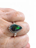 Making Waves Jewelry and Accessories teardrop ring with iridescent dark gemstone in a twisted sterling silver setting.