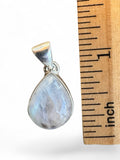 Making Waves Jewelry and Accessories teardrop moonstone pendant in 925 sterling silver next to a one-inch ruler