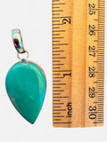 Making Waves Jewelry and Accessories teardrop pendant with sea-foam green gemstone in 925 sterling silver next to ruler