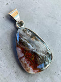 Making Waves Jewelry and Accessories teardrop pendant with a polished multi-colored gemstone in a sterling silver bezel