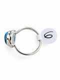 Making Waves Jewelry and Accessories teardrop ring with a blue stone and dark inclusions set in polished sterling silver.