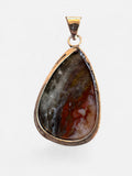 Making Waves Jewelry and Accessories teardrop pendant with a polished multi-colored gemstone in a sterling silver bezel
