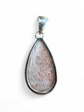 Making Waves Jewelry and Accessories teardrop sunstone pendant with geometric inclusions in a sterling silver bezel.