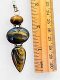 Making Waves Jewelry and Accessories triple stone Tiger's Eye pendant in 925 sterling silver next to a ruler