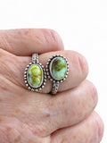 Making Waves Jewelry and Accessories sterling silver bypass ring with two oval green turquoise stones and leaf detail.