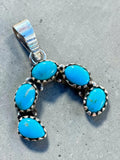 Making Waves Jewelry and Accessories sterling silver horseshoe pendant with five oval-cut sky-blue turquoise stones.