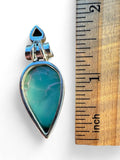 Making Waves Jewelry and Accessories teardrop turquoise pendant in 925 sterling silver with a small blue gemstone top.