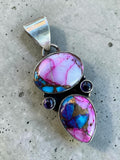 Making Waves Jewelry and Accessories artisan sterling silver pendant with pink and blue turquoise and purple gemstones.