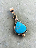 Making Waves Jewelry and Accessories turquoise teardrop pendant in 925 sterling silver with rope and bead detailing.