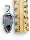 Making Waves Jewelry and Accessories sterling silver pendant with pink and blue turquoise inlay next to a ruler
