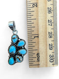 Making Waves Jewelry and Accessories turquoise cluster pendant in sterling silver with serrated bezels next to a ruler
