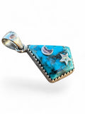 Making Waves Jewelry and Accessories turquoise pendant with sterling silver moon and star accents in a serrated bezel.