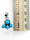 Making Waves Jewelry and Accessories turquoise cluster pendant in sterling silver with rope detailing next to a ruler.