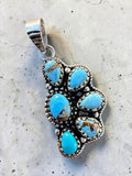 Making Waves Jewelry and Accessories sterling silver pendant featuring five turquoise stones with rope-edge detailing.