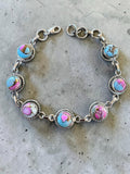 Making Waves Jewelry and Accessories artisan bracelet with multi-colored turquoise stones in twisted sterling silver