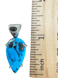 Making Waves Jewelry and Accessories handcrafted turquoise teardrop pendant in 925 sterling silver with dark gemstone bail