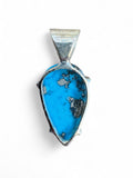 Making Waves Jewelry and Accessories handcrafted teardrop pendant with turquoise stone and 925 sterling silver setting.