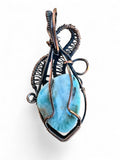 Making Waves Jewelry and Accessories artisan pendant featuring a blue gemstone wrapped in intricate oxidized copper wire